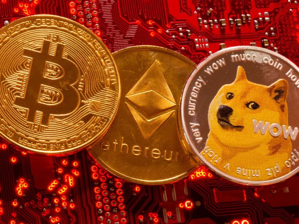 Representations of cryptocurrencies Bitcoin, Ethereum and DogeCoin are placed on PC motherboard in this illustration taken