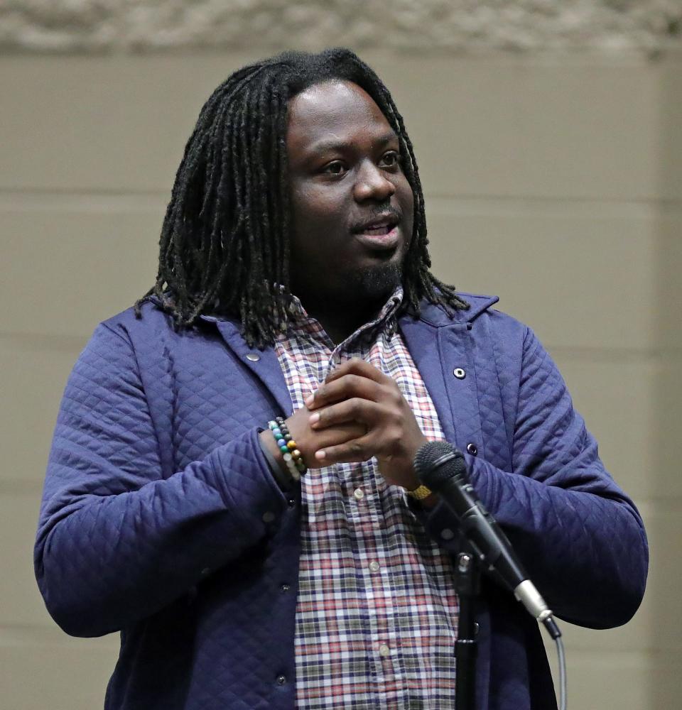Imokhai Okolo, a local attorney and community organizer, speaks during a town hall event Thursday at Garfield CLC in Akron.