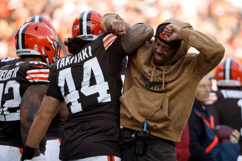 Cleveland Browns linebacker Sione Takitaki (44) is congratulated by cornerback Greg Newsome II (0) after intercepting a pass during an NFL football game against the Arizona Cardinals, Sunday, Nov. 5, 2023, in Cleveland. (AP Photo/Kirk Irwin)