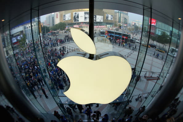 Apple staff members celebrate as customers coming into the Wangfujing store. (Photo by Feng Li/Getty Images)