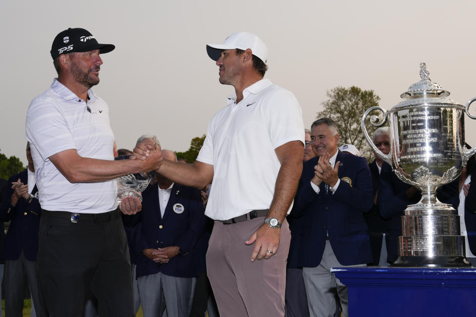Michael Block, low club professional, and Brooks Koepka winner, shake hands after the PGA Championship golf tournament at Oak Hill Country Club on Sunday, May 21, 2023, in Pittsford, N.Y. (AP Photo/Seth Wenig)