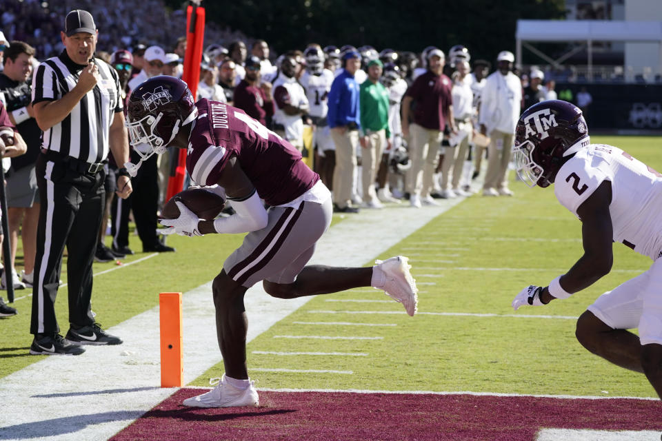 Mississippi State wide receiver Caleb Ducking reaches for a four-yard touchdown pass reception while Texas A&M defensive back Denver Harris (2) pursues during the first half of an NCAA college football game in Starkville, Miss., Saturday, Oct. 1, 2022. (AP Photo/Rogelio V. Solis)