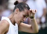 Flavia Pennetta of Italy wipes her brow during her match against Zarina Diya of Kazakhstan at the Wimbledon Tennis Championships in London, June 29, 2015. REUTERS/Toby Melville