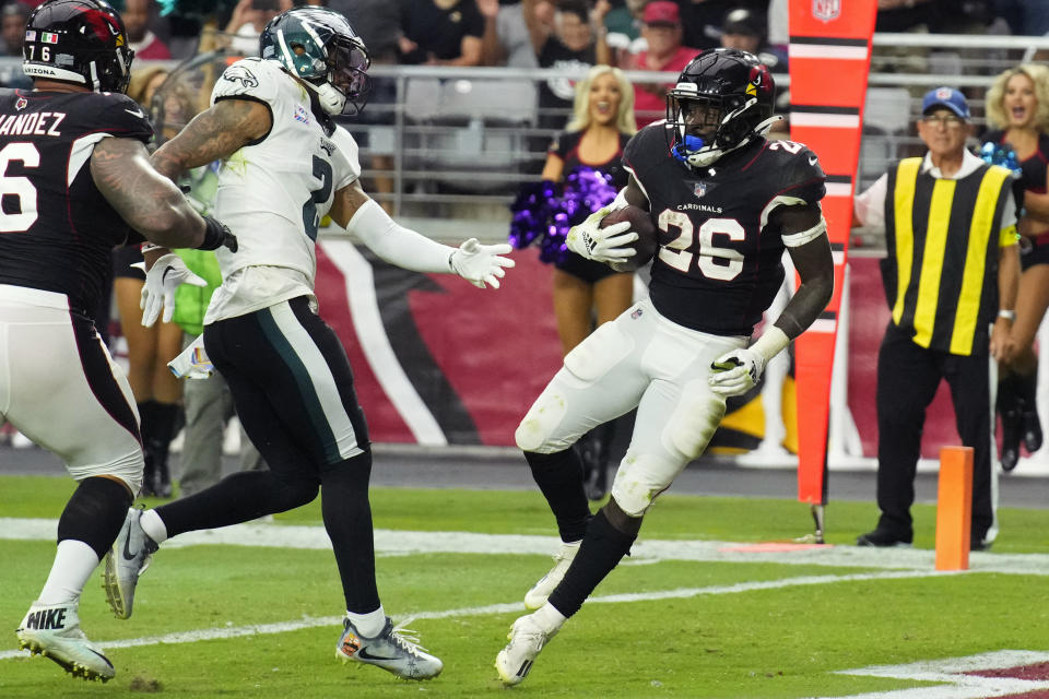 Arizona Cardinals running back Eno Benjamin (26) scores a touchdown against Philadelphia Eagles cornerback Darius Slay (2) during the second half an NFL football game, Sunday, Oct. 9, 2022, in Glendale, Ariz. (AP Photo/Rick Scuteri)