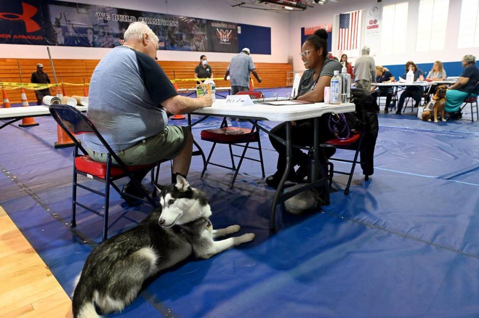 Dan Crumpler and Critter are checked into the evacuation shelter at Manatee High School by Manatee County Animal Welfare’s Katrina Ivory as Hurricane Ian slowly approaches on Sept. 27, 2022.