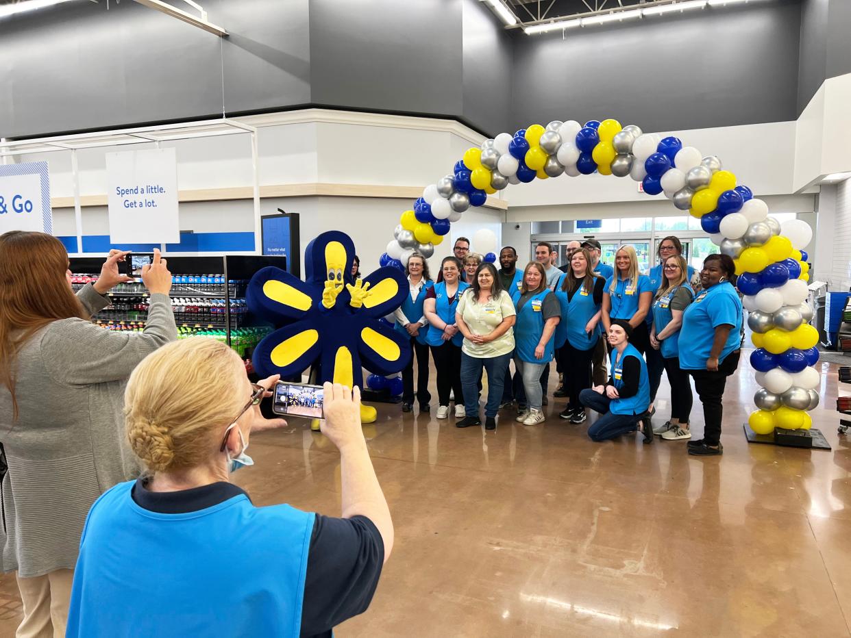 Associates at the Walmart Supercenter pose with the company mascot Spark (at left center) following a celebration Friday of the completion of a $6 million remodeling of the 203,000-square-foot store.