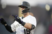 Colorado Rockies' Randal Grichuk gestures to the dugout after his two-run single off Miami Marlins relief pitcher Huascar Brazoban during the fifth inning of a baseball game Tuesday, May 23, 2023, in Denver. (AP Photo/David Zalubowski)