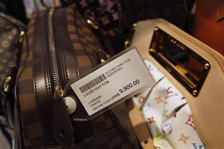 A second-hand Louis Vuitton handbag is displayed with a price-tag of HK$9,900 ($1,269) from its original price of HK$15,200 (US$1,949) at a Milan Station outlet in Hong Kong September 2, 2013. REUTERS/Bobby Yip