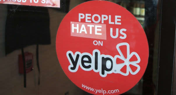 A Yelp sticker. The review site has come under fire by small businesses who question its business practices.