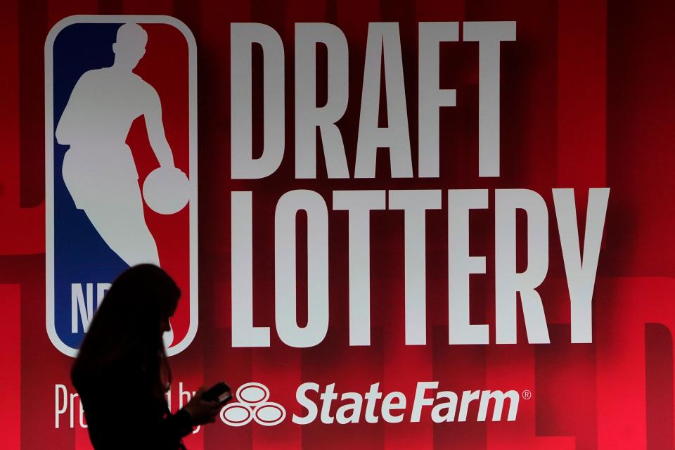People walk past the 2023 NBA draft lottery board at McCormick Place West on May 16, 2023, in Chicago.