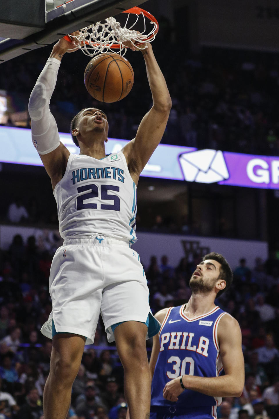 Charlotte Hornets forward PJ Washington (25) dunks over Philadelphia 76ers guard Furkan Korkmaz (30) in the second half of a preseason NBA basketball game in Winston-Salem, N.C., Friday, Oct. 11, 2019. (AP Photo/Nell Redmond)