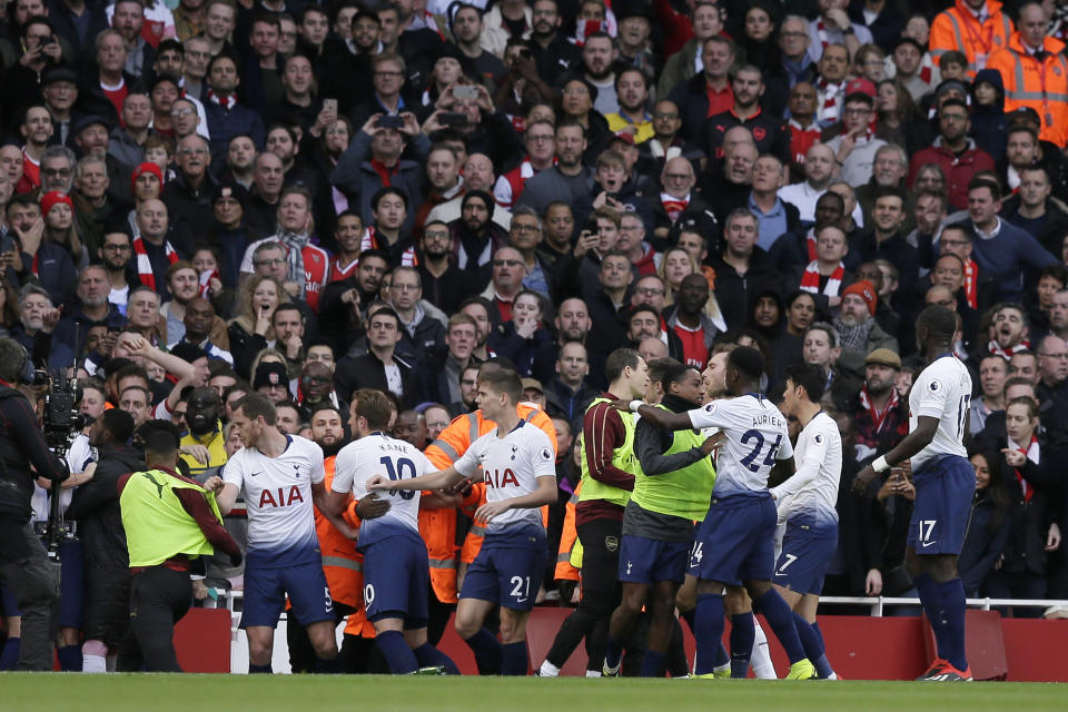 Tottenham and Arsenal players fight during the English Premier League soccer match between Arsenal and Tottenham Hotspur at the Emirates Stadium in London, Sunday Dec. 2, 2018. (AP Photo/Tim Ireland)