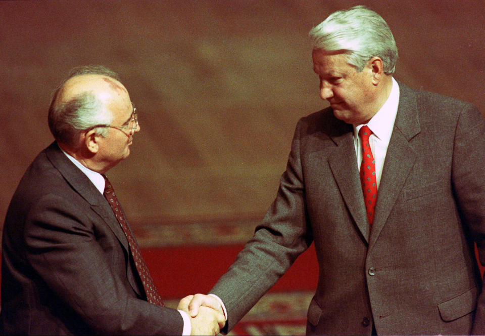 FILE - Russian President Boris Yeltsin, right, shakes hands with Soviet President Mikhail Gorbachev and thanks him for meeting with the Russian People's Deputies at the Russian Federation building, in Moscow, Russia on Aug. 23, 1991. (AP Photo/Boris Yurchenko, File)