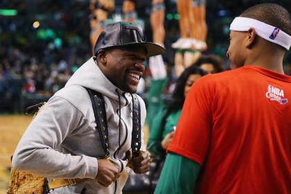 Floyd Mayweather talks with Isaiah Thomas of the Boston Celtics after a game on Jan. 29. (Getty)