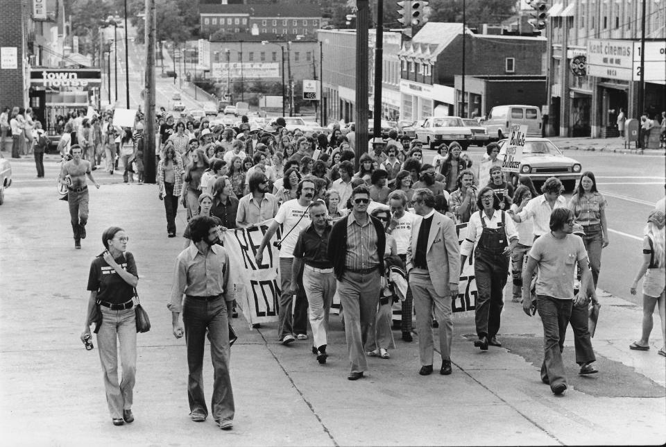 Marching down the same street in downtown Kent where his late daughter protested the Vietnam War in 1969, Arthur Krause (with sunglasses at lead of group) joins a protest against building a Gym Annex at Kent State University on Aug. 20, 1977. Allison Krause was killed by the Ohio National Guard during student protests May 4, 1970. A 1969 Moratorium Day march saw Allison also protest on Main Street.