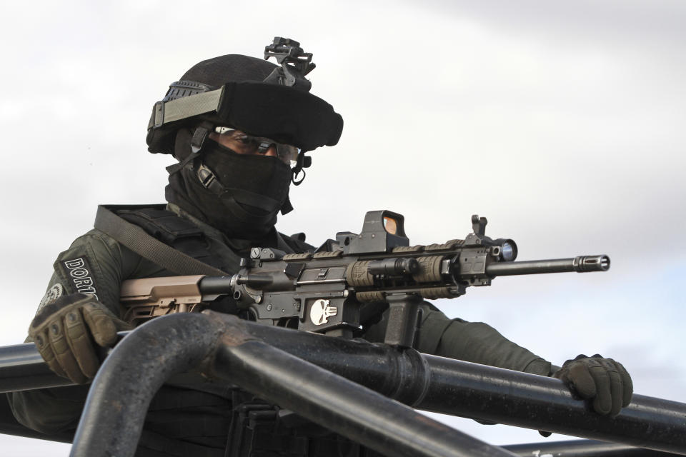 Chihuahua state police officers man a checkpoint in Janos, Chihuahua state, northern Mexico, Tuesday.