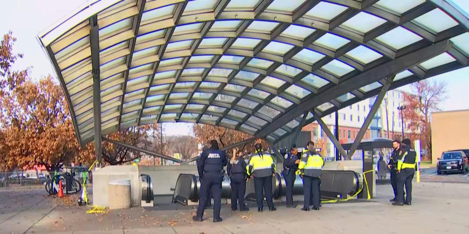 Investigators stand outside the scene of a shooting at the Benning Road Metro station in  Washington, D.C. (WRC)