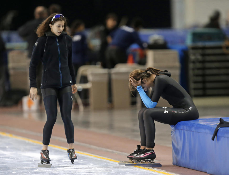 First-place finisher Maria Lamb, left, skates up to Petra Acker after competing in the women's 5,000 meters during the U.S. Olympic speedskating trials Wednesday, Jan. 1, 2014, in Kearns, Utah. (AP Photo/Rick Bowmer)