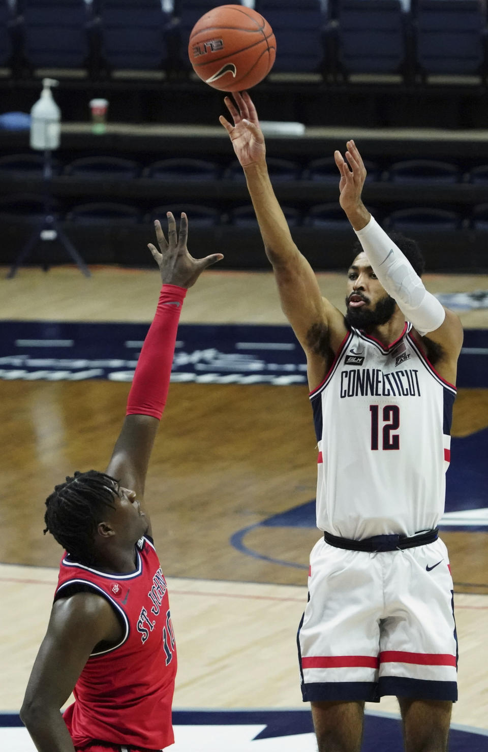 UConn forward Tyler Polley (12) shoots against St. John's in the first half of an NCAA college basketball game in Storrs, Connecticut, Monday, Jan. 18, 2021. (David Butler II/Pool photo via AP)