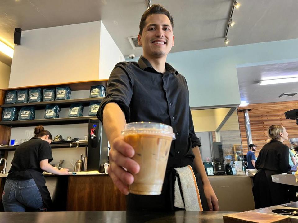 Kevin Robles, lead barista at Chocolate Fish Coffee Roasters at 4749 Folsom Blvd. presents the latest fall menu item: a Fall Flat White with Pumpkin Chai. Robles has been working at the coffee shop for a year and three months.