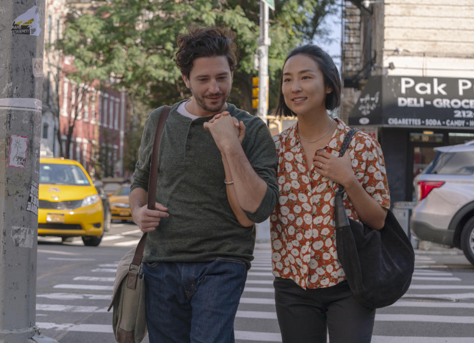 This image released by A24 shows John Magaro, left, and Greta Lee in a scene from "Past Lives." (Jon Pack/A24 via AP)