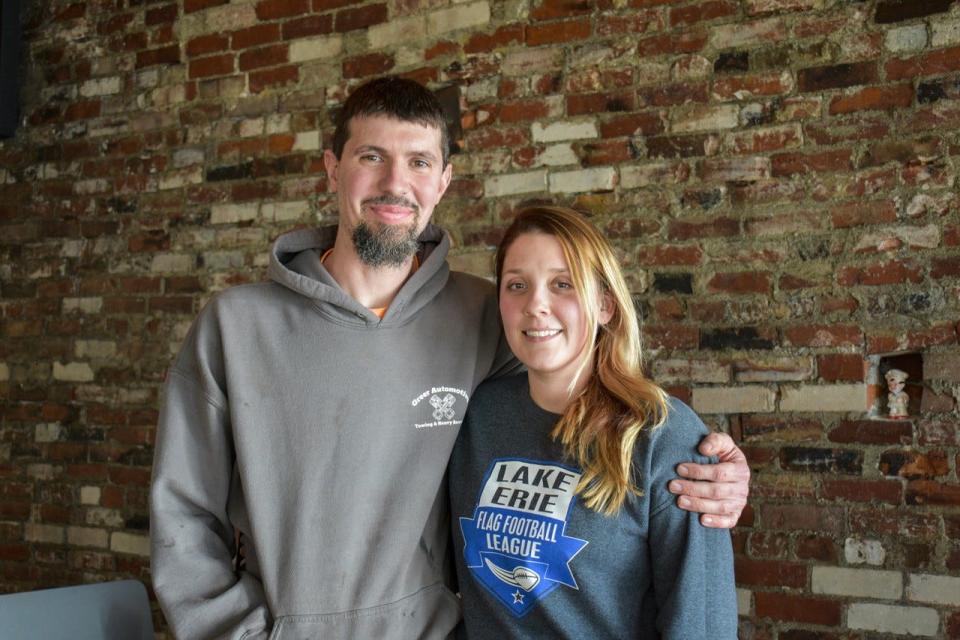 Zane and Chelsea Greer, owners of River Property Rentals, own the building that houses Pisanello’s Pizza. As they remodeled the building this winter, they focused on historic restoration. Behind them is the original brick wall they exposed in the shop’s dining room.