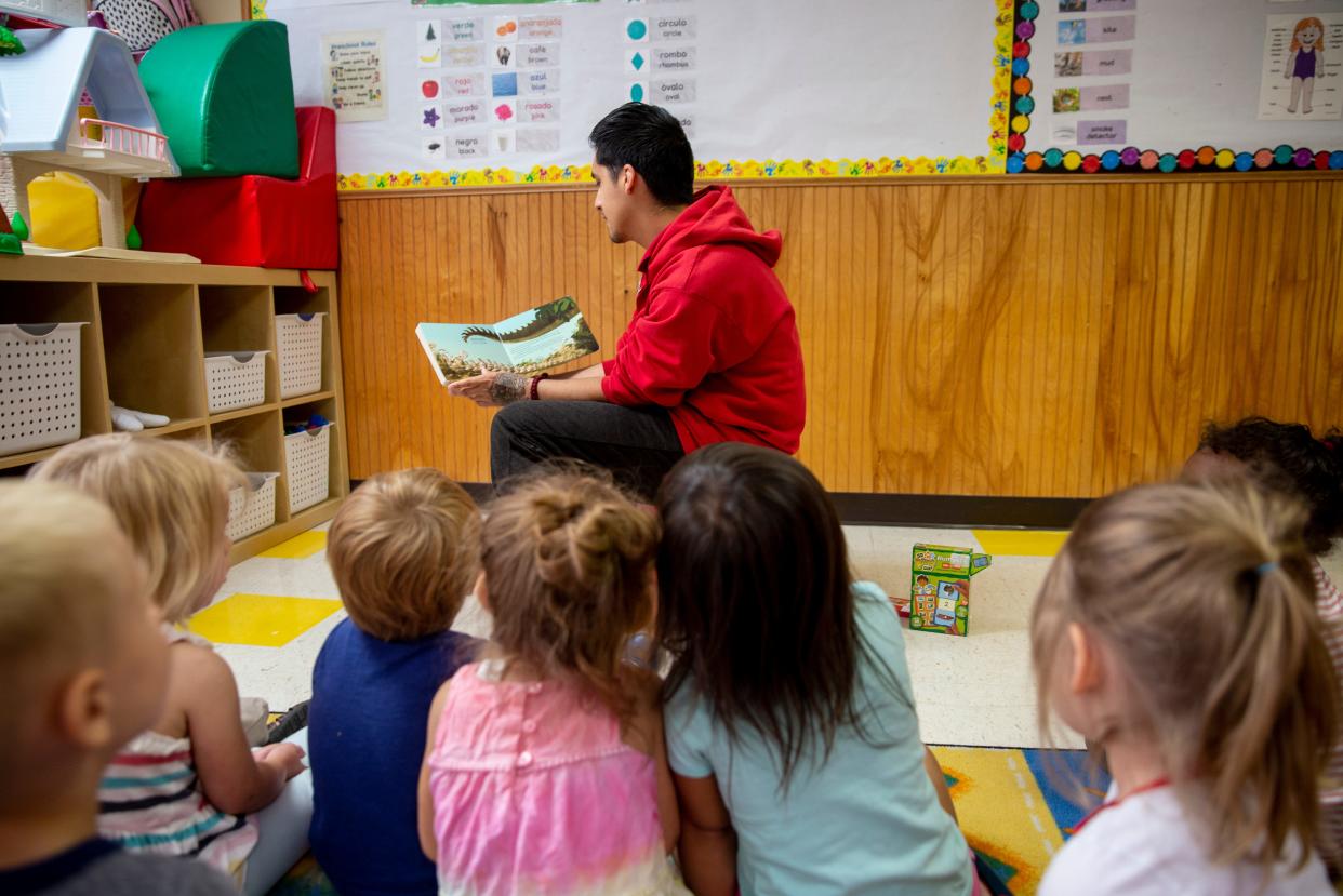 Pre-school children listen to a story at Apple Tree Children's Center in 2019.