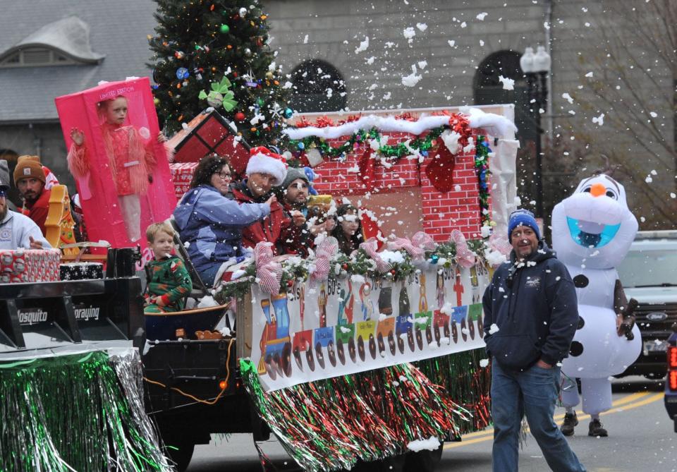 "Snow" flies from the Quincy Town River Yacht Club float during the 69th annual Quincy Christmas Parade.