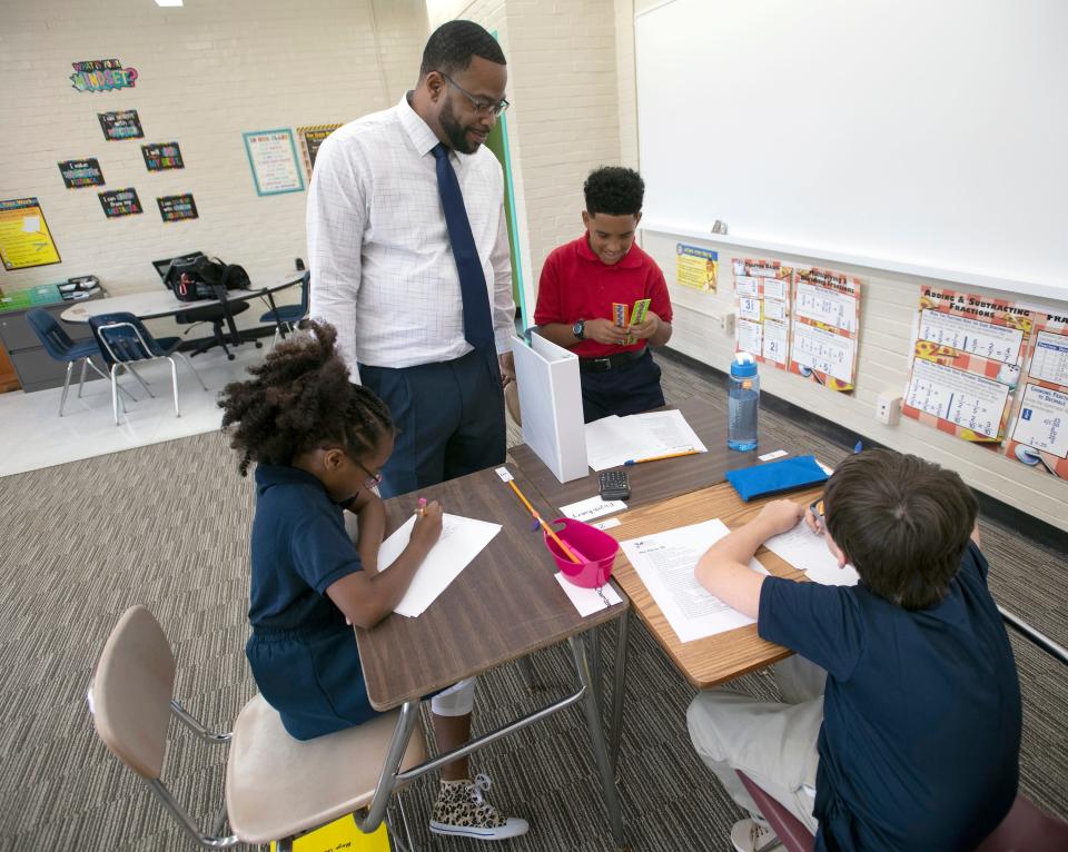 Fifth-grade teacher Kenyon Moody talks with a group of new students on the first day of school at the Dixon School of Arts and Sciences on Aug. 12, 2019. This school year, the school will offer a new theater boot camp in partnership with the Equity Project Alliance and the Children's Theater Company.