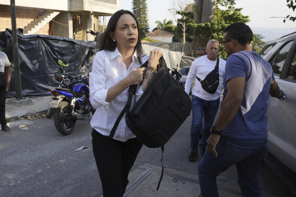 FILE - Opposition leader María Corina Machado arrives at her headquarters in order to give a press conference regarding the arrest order for her campaign manager and eight other opposition members for alleged involvement in a conspiracy plot to destabilize the government, in Caracas, Venezuela, March 20, 2024. Machado, who swept an opposition coalition’s primary election with more than 90% of votes, was disqualified by Venezuelan authorities to hold public office for 15 years. (AP Photo/Ariana Cubillos, File)