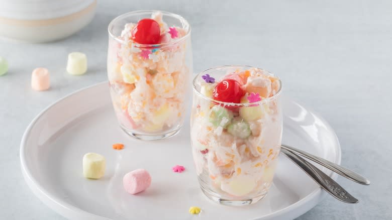 Two small ambrosia salads in glasses with spoons