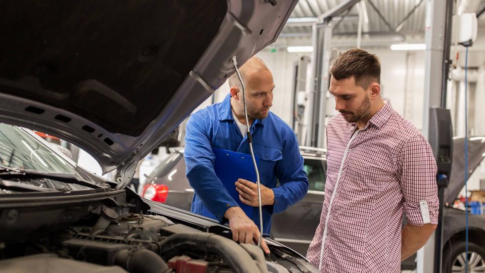 mechanic talking with customer