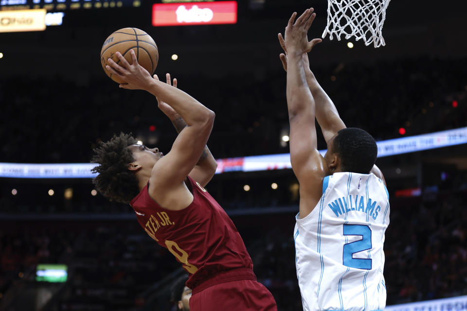 Cleveland Cavaliers guard Craig Porter shoots against Charlotte Hornets forward Grant Williams (2) during the first half of an NBA basketball game, Monday, March 25, 2024, in Cleveland. (AP Photo/Ron Schwane)