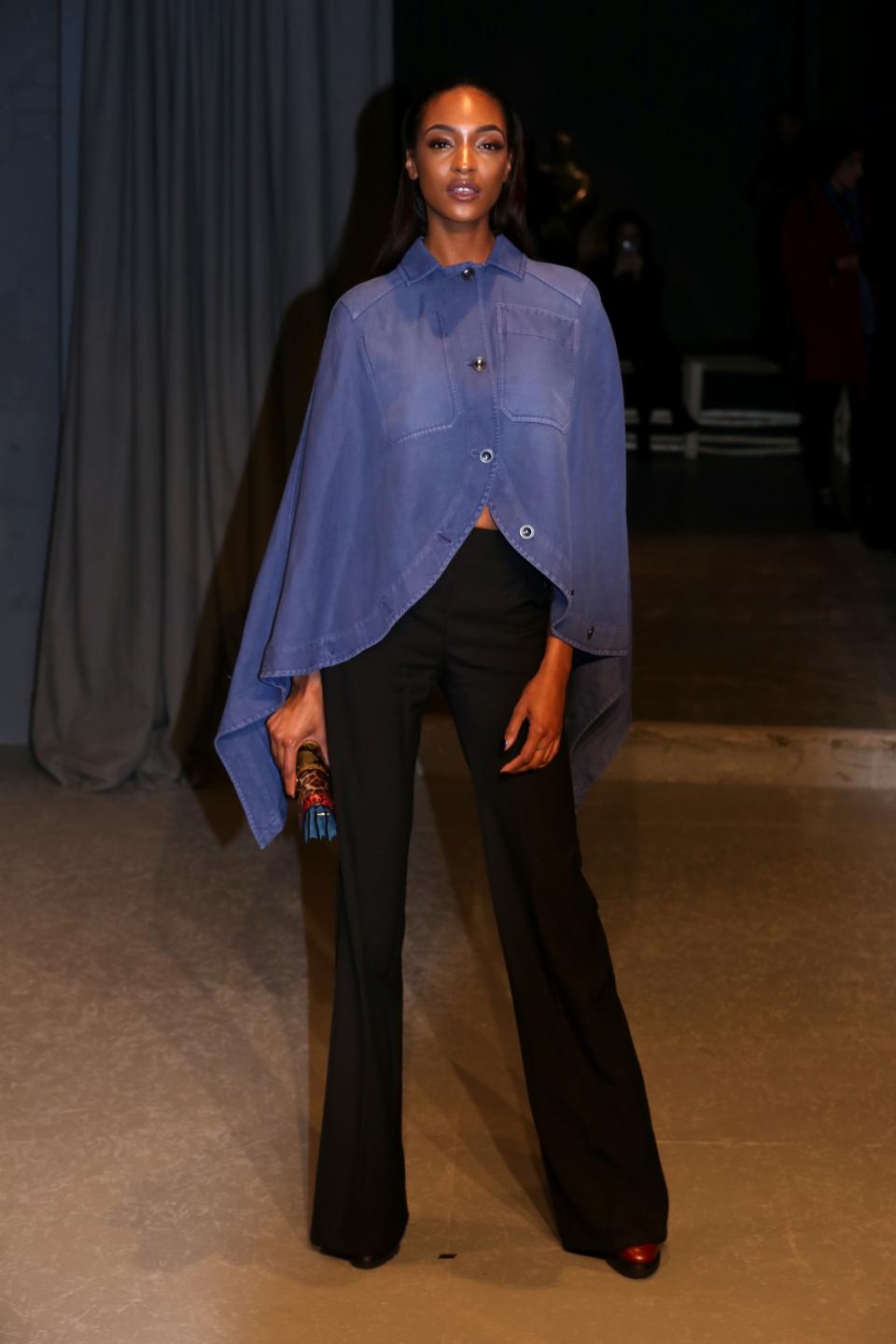 <p>Jourdan Dunn wore a chambray cape and flared trousers. <i>[Photo: PA]</i> </p>