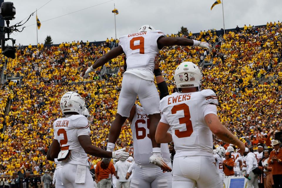 Texas running back Jerrick Gibson, center, celebrates a touchdown with teammates, including quarterback Quinn Ewers, right, during the 31-12 win at Michigan. The Horns host UTSA on Saturday, and head coach Steve Sarkisian is wary of upsets that occur routinely in college football.