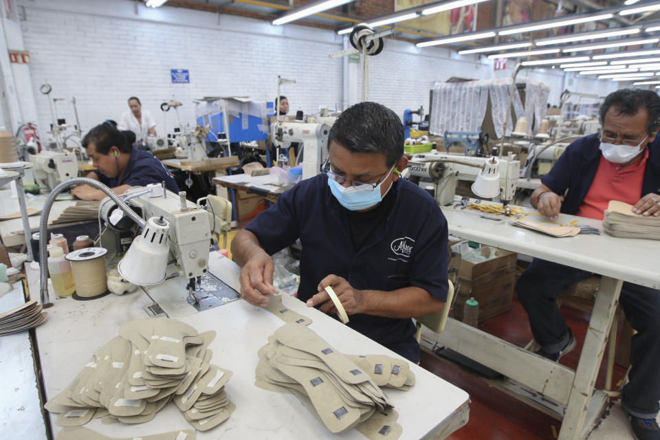 A man works in a shoe maquiladora or factory, in Leon, Mexico, Monday, Feb. 7, 2023. It has been nearly two years since the United States began pressing Mexico over labor rights violations, by using rapid dispute resolution methods (RRM) contained in the U.S.-Mexico Canada free trade agreement. (AP Photo/Mario Armas)