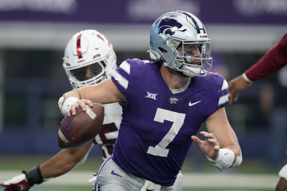 Kansas State quarterback Skylar Thompson (7) scrambles out of the pocket under pressure from Stanford in the second half of an NCAA college football game in Arlington, Texas, Saturday, Sept. 4, 2021. (AP Photo/Tony Gutierrez)