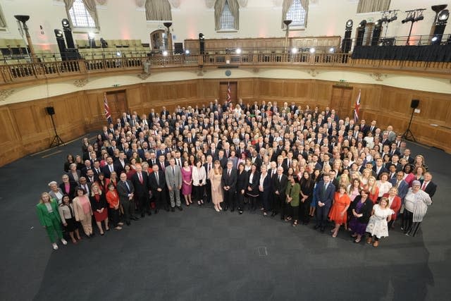 Prime Minister Sir Keir Starmer seem from above standing with the Labour Party's MPs 