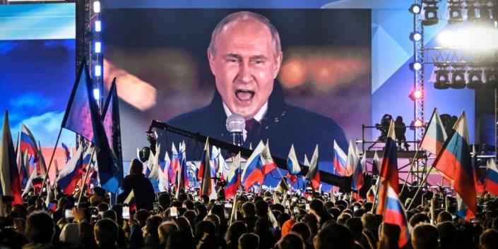 Russian President Vladimir Putin is seen on a screen set at Red Square as he addresses a rally and a concert marking the annexation of four regions of Ukraine Russian troops occupy - Lugansk, Donetsk, Kherson and Zaporizhzhia, in central Moscow on September 30, 2022.