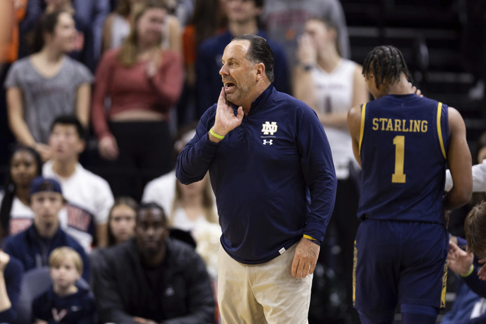 Notre Dame head coach Mike Brey yells to his team during the first half of an NCAA college basketball game against Virginia in Charlottesville, Va., Saturday, Feb. 18, 2023. (AP Photo/Mike Kropf)