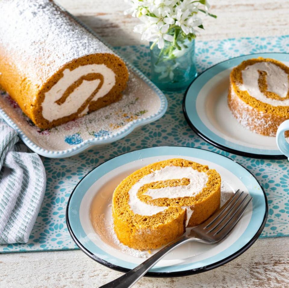 pumpkin roll cake on blue and white plate