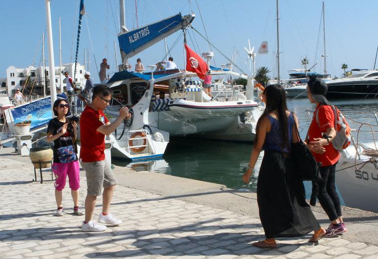 File picture shows tourists visiting the Marina in Monastir, a popular tourist destination near Sousse, 140 kilometres (90 miles) south of the Tunisian capital