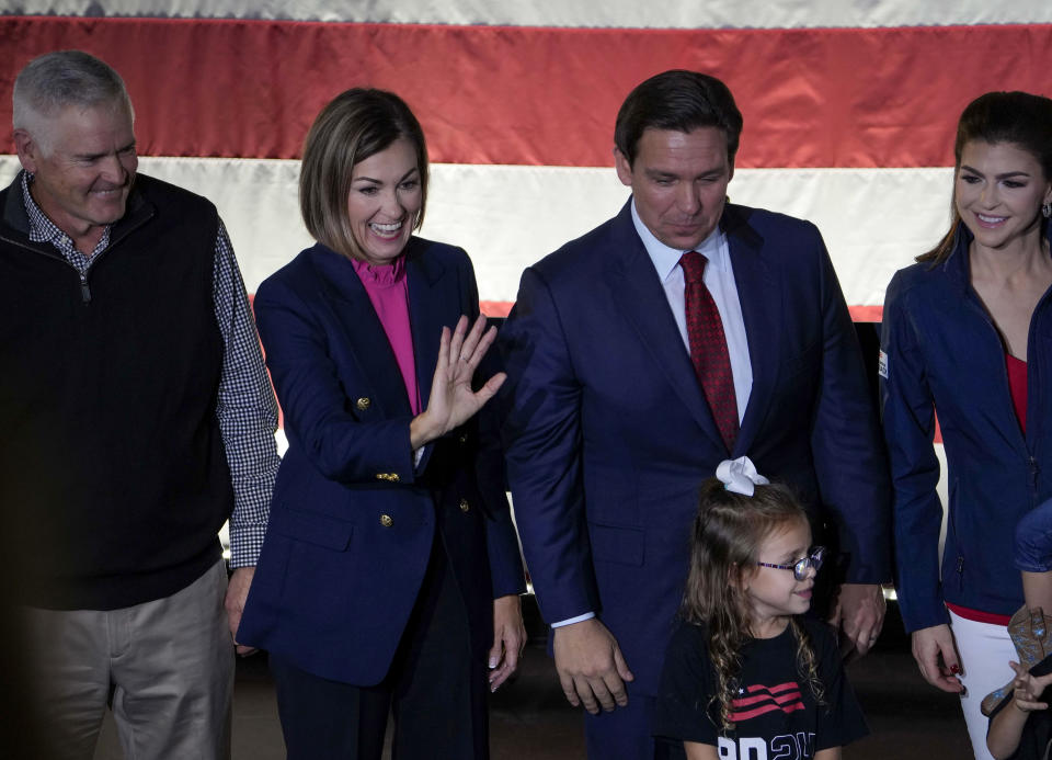 Iowa Gov. Kim Reynolds, second from left, joins Republican presidential candidate Florida Gov. Ron DeSantis on stage during a rally, Monday, Nov. 6, 2023, in Des Moines, Iowa, after she endorsed him.. (AP Photo/Bryon Houlgrave)
