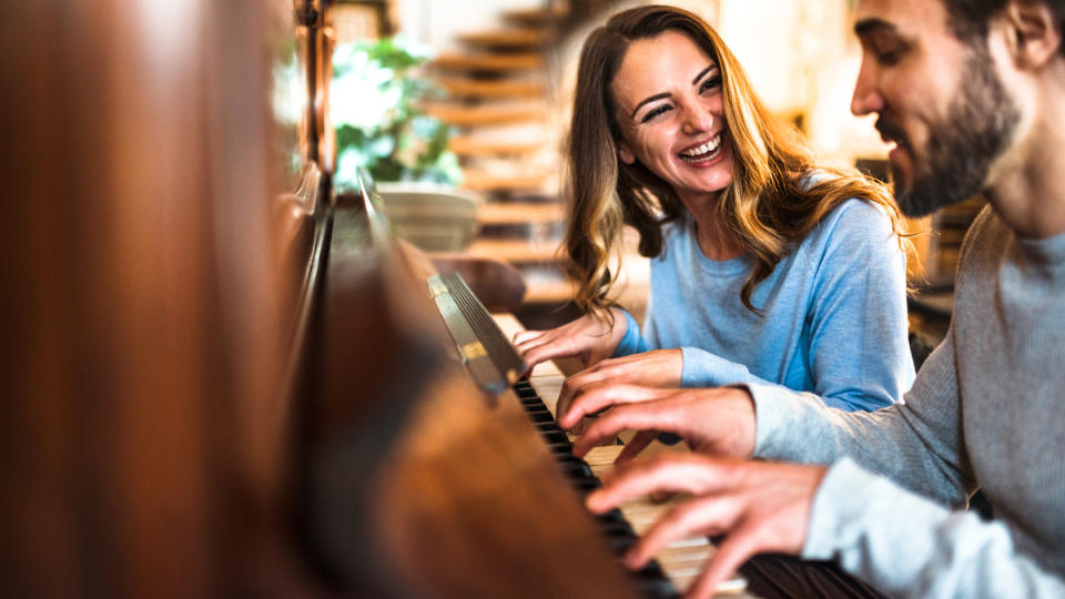 Couple enjoying themselves at a piano