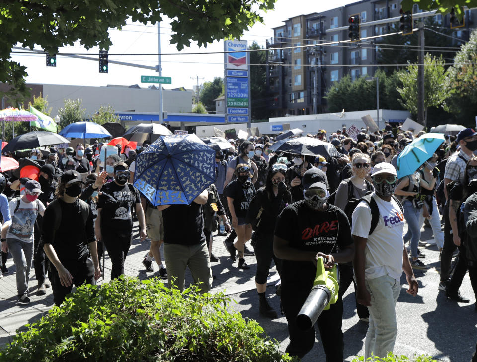 Protesters march near the King County Juvenile Detention Center, Saturday, July 25, 2020, in Seattle in support of Black Lives Matter and against police brutality and racial injustice. (AP Photo/Ted S. Warren)