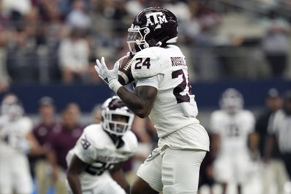 Texas A&M linebacker Chris Russell Jr. (24) grabs the ball for a turnover on his way to score a touchdown during the second half of an NCAA college football game against Arkansas, Saturday, Sept. 30, 2023, in Arlington, Texas. (AP Photo/LM Otero)