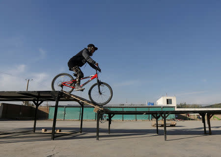 An Afghan young cyclist performs her tactics during an exercise in Kabul, Afghanistan November 15, 2016. REUTERS/Omar Sobhani