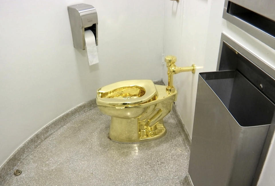This Sept. 16, 2016 file image made from a video shows the 18-karat toilet, titled “America,” by Maurizio Cattelan in the restroom of the Solomon R. Guggenheim Museum in New York. Four men have been charged over the theft of an 18-carat gold toilet from Blenheim Palace, the sprawling English mansion where British wartime leader Winston Churchill was born. The toilet, valued at 4.8 million pounds, or $5.95 million, was the work of Italian conceptual artist Maurizio Cattelan. (AP Photo, File)