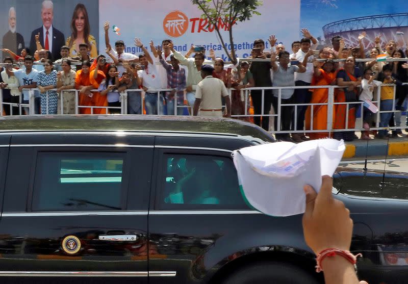 U.S. first lady Melania Trump waves from the inside of the armored limousine known as "The Beast" as the vehicle passes by enroute to Gandhi Ashram in Ahmedabad