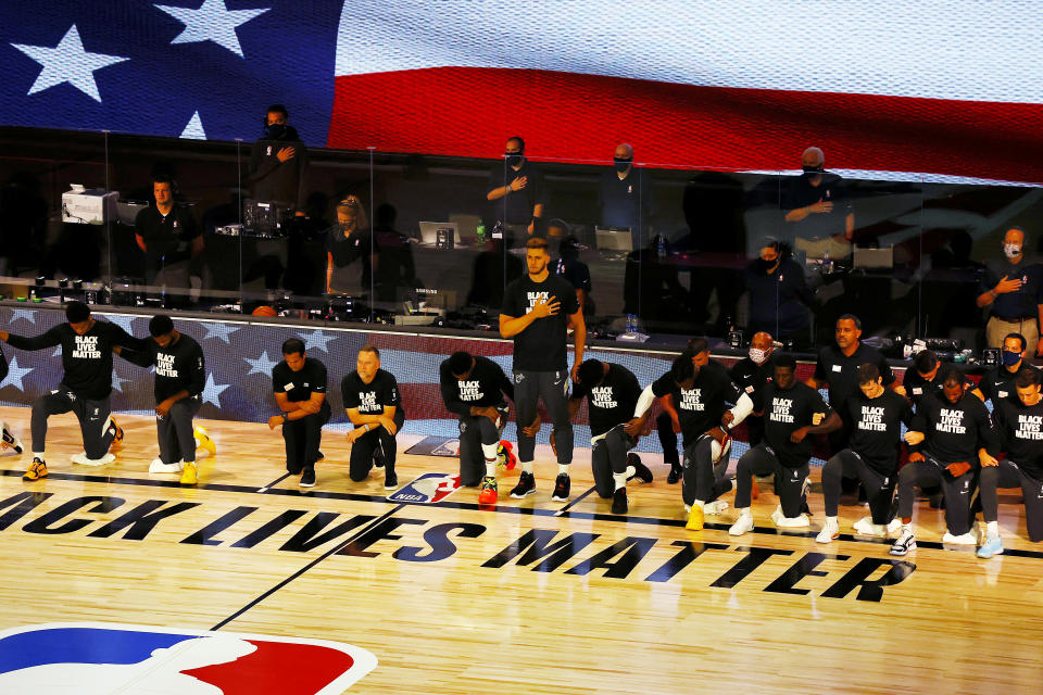 LAKE BUENA VISTA, FLORIDA - AUGUST 01:  Meyers Leonard of the Miami Heat stands during the National Anthem before the start of a hame against the Denver Nuggets at HP Field House at ESPN Wide World Of Sports Complex on August 01, 2020 in Lake Buena Vista, Florida. NOTE TO USER: User expressly acknowledges and agrees that, by downloading and or using this photograph, User is consenting to the terms and conditions of the Getty Images License Agreement. (Photo by Kevin C. Cox/Getty Images)